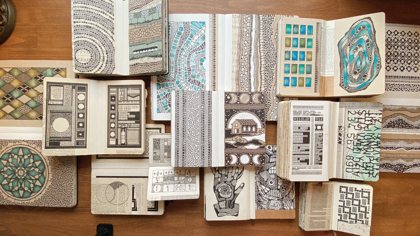 Collection of patterned books on a wooden table