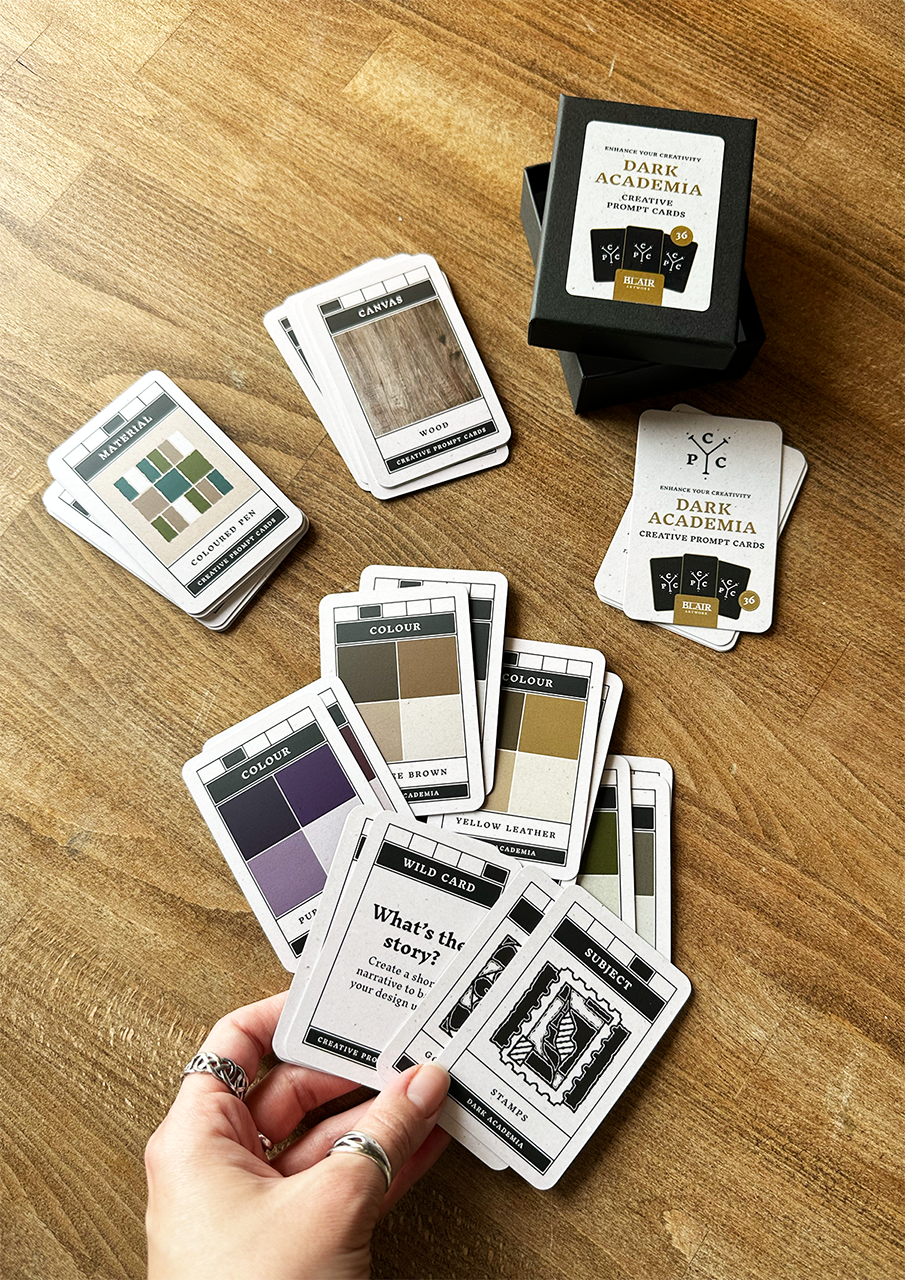Card game with 'Dark Academia' theme on a wooden surface