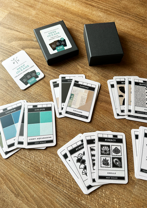 Collection of playing cards with descriptive text on a wooden surface