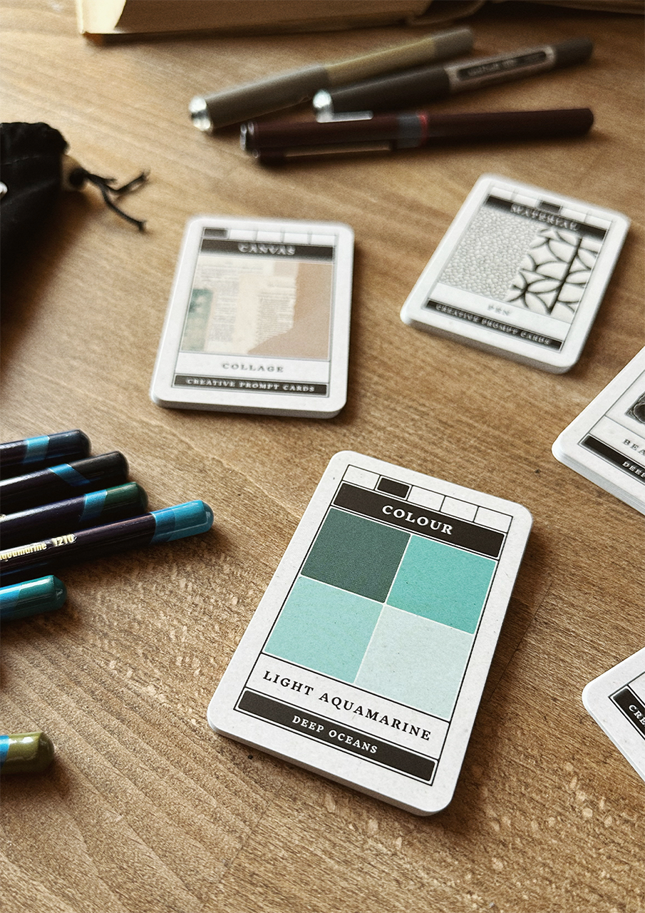 Color swatch cards and markers on a wooden surface