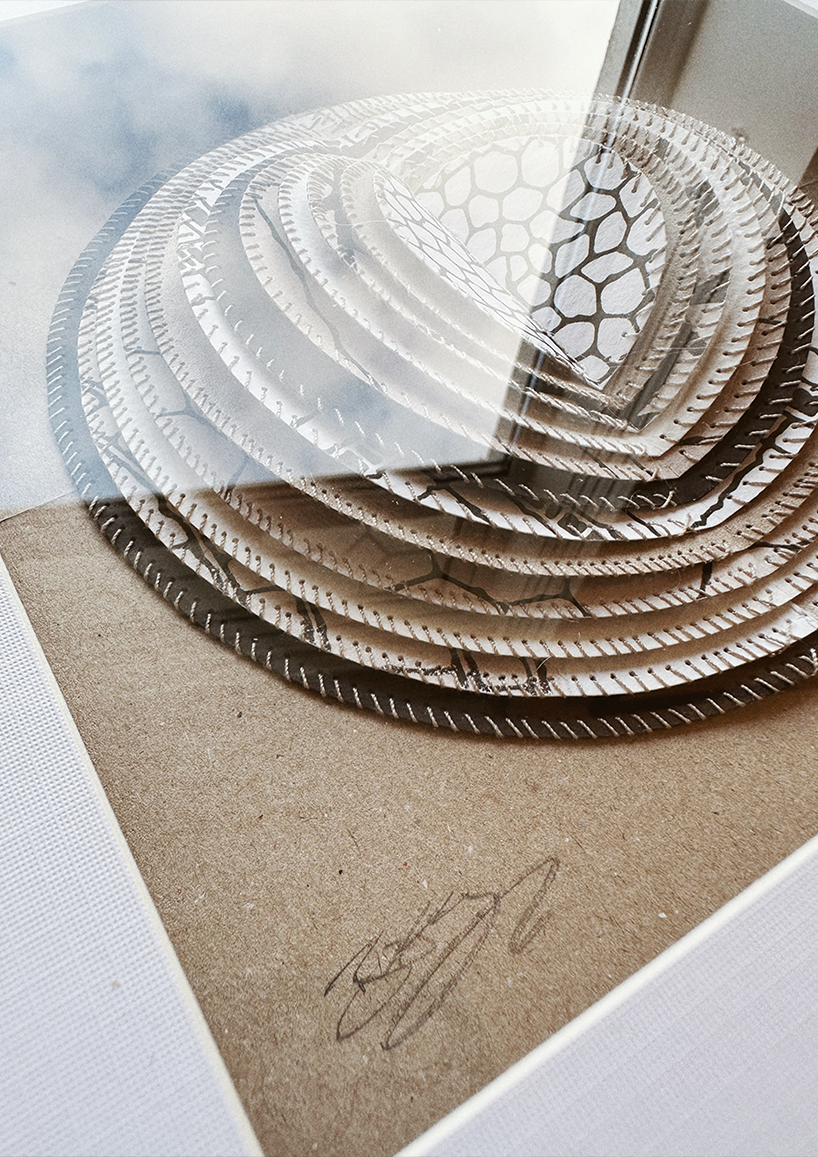 A framed hand-stitched artwork depicting a large circular paper moon.