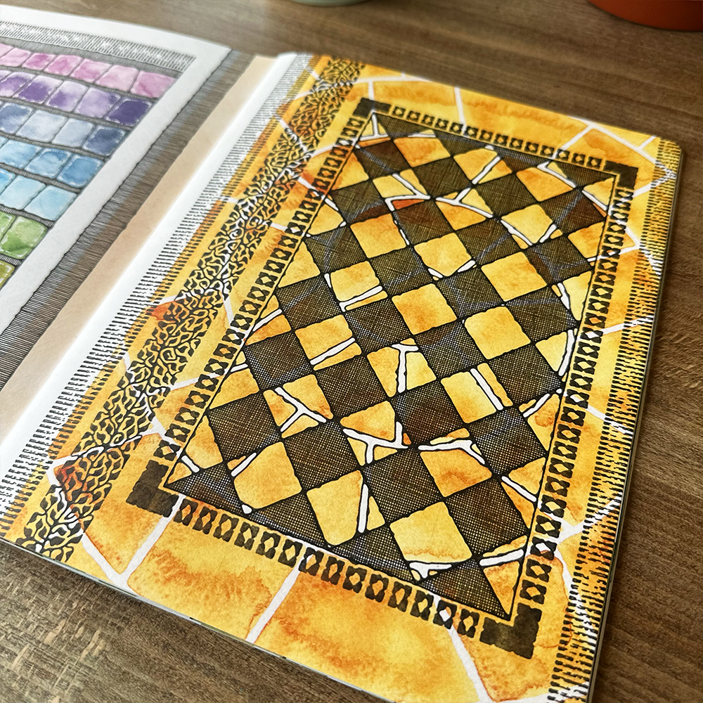 Patterned book page with geometric design on a wooden surface