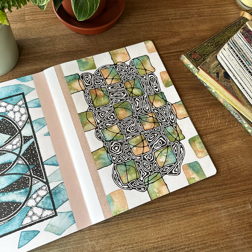 Coloring book with mandala designs on a wooden surface