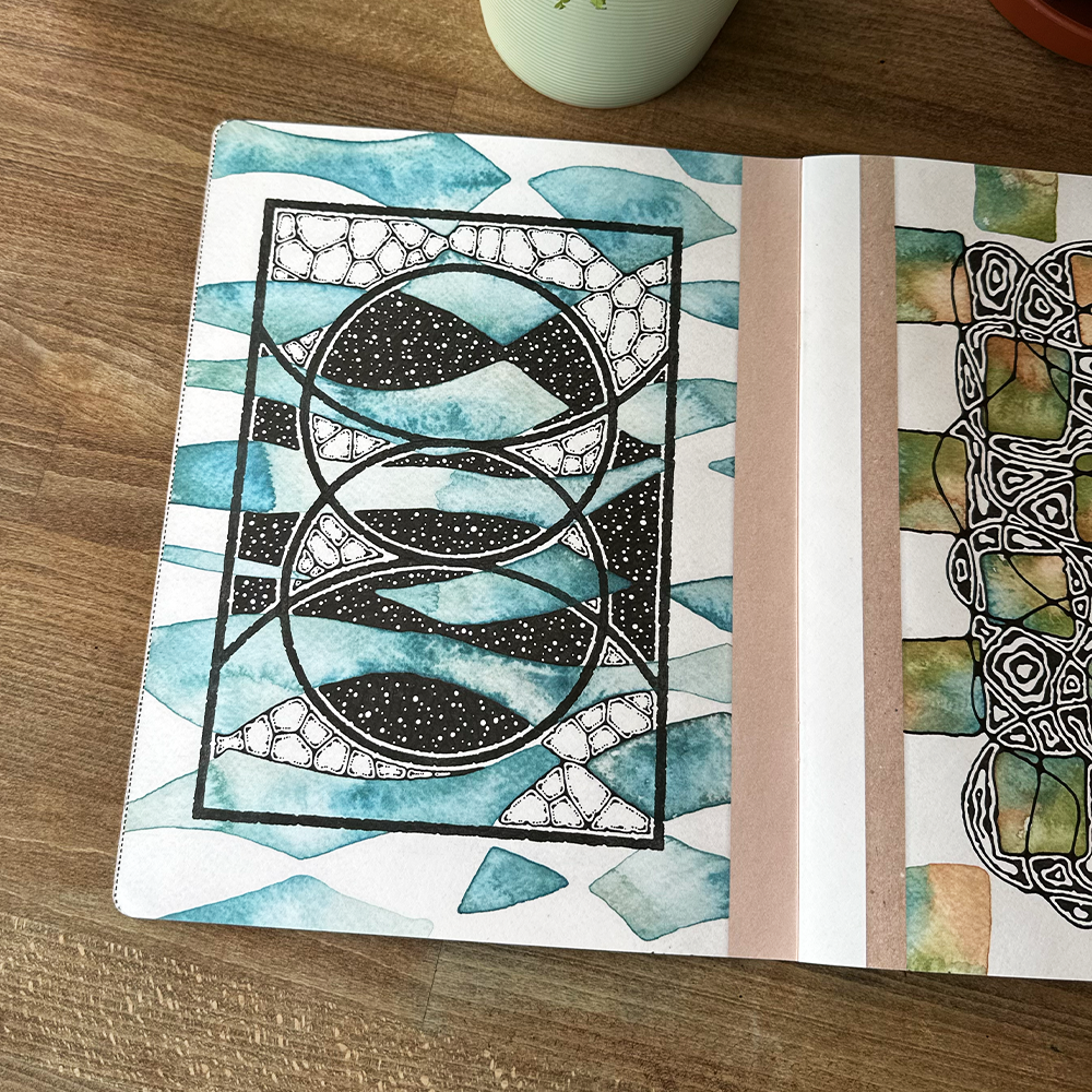 Artistic notebook with geometric design on a wooden surface
