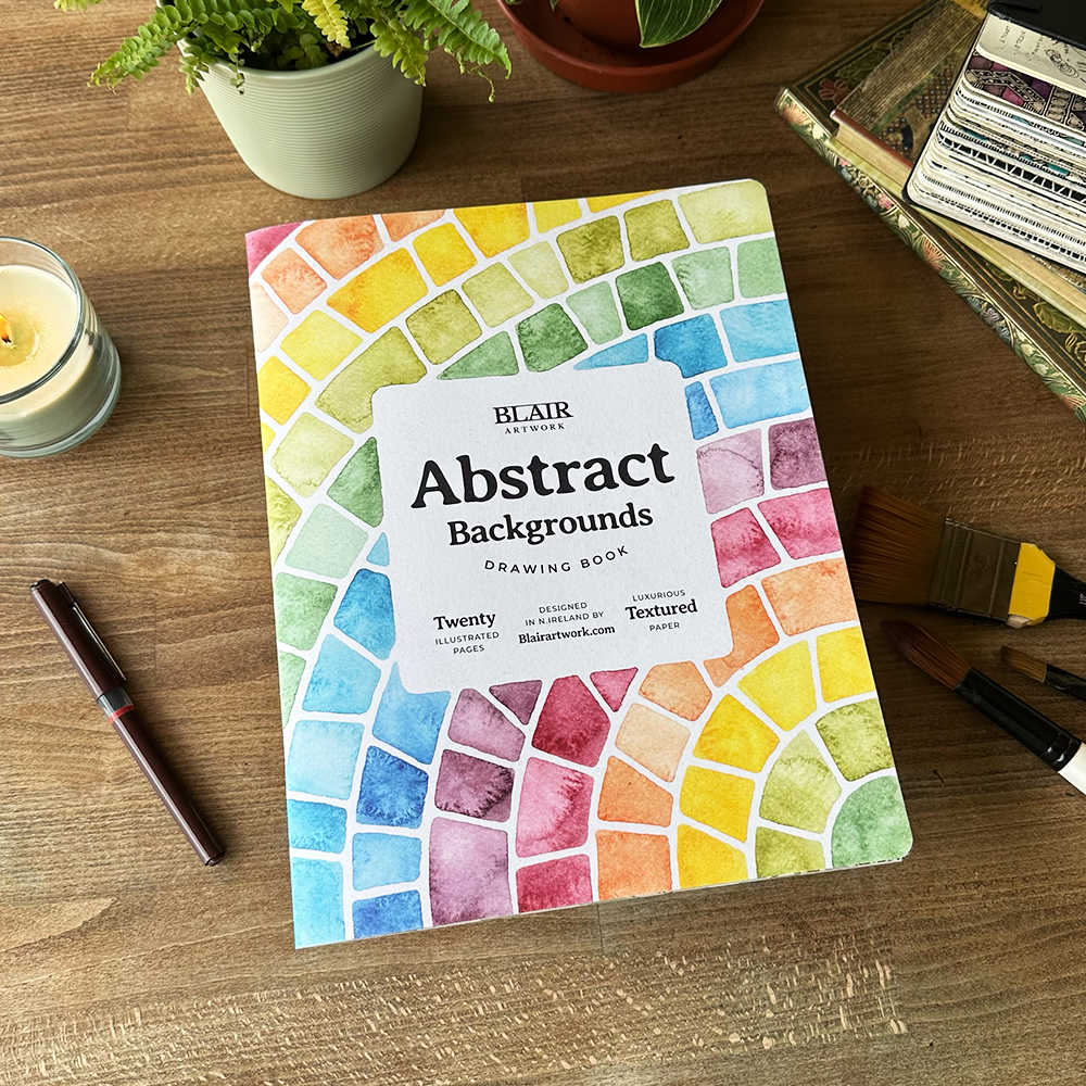 Colorful abstract backgrounds drawing book on a wooden surface with a pen and plant.