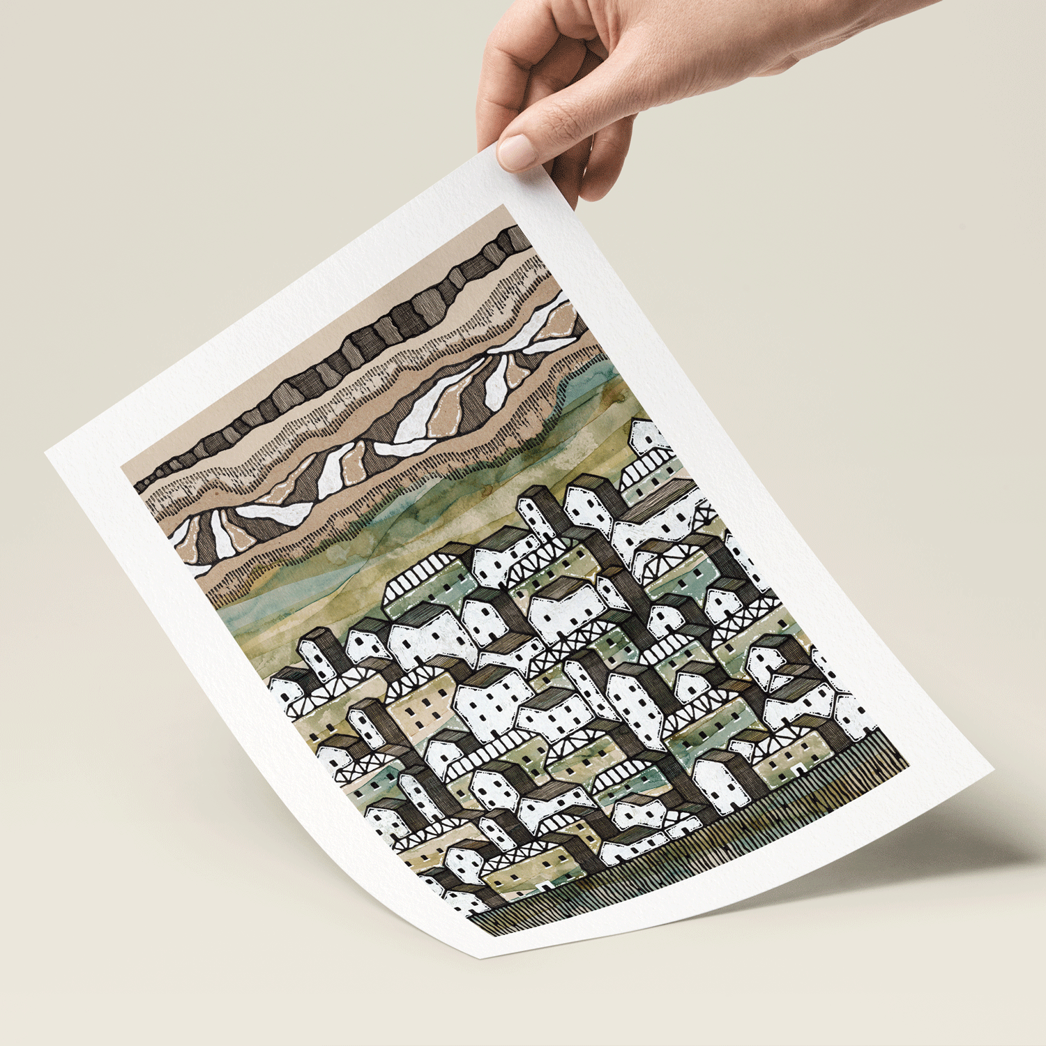 Illustration of towns and mountains in green and brown print held in hand