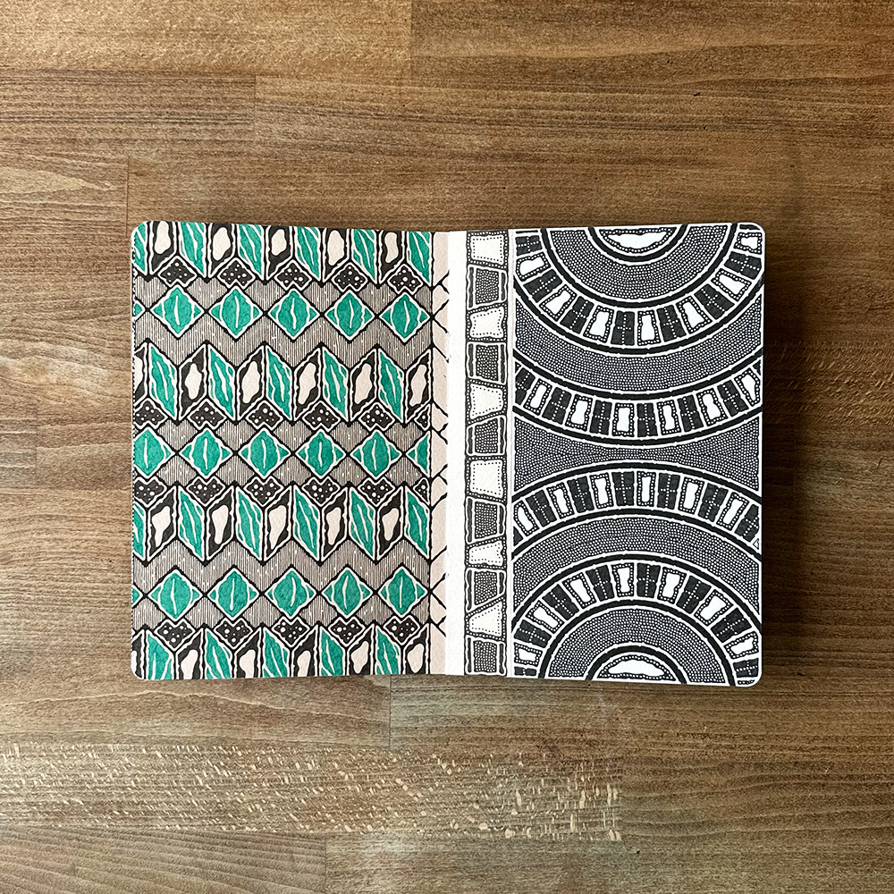 Two patterned pages on a wooden surface
