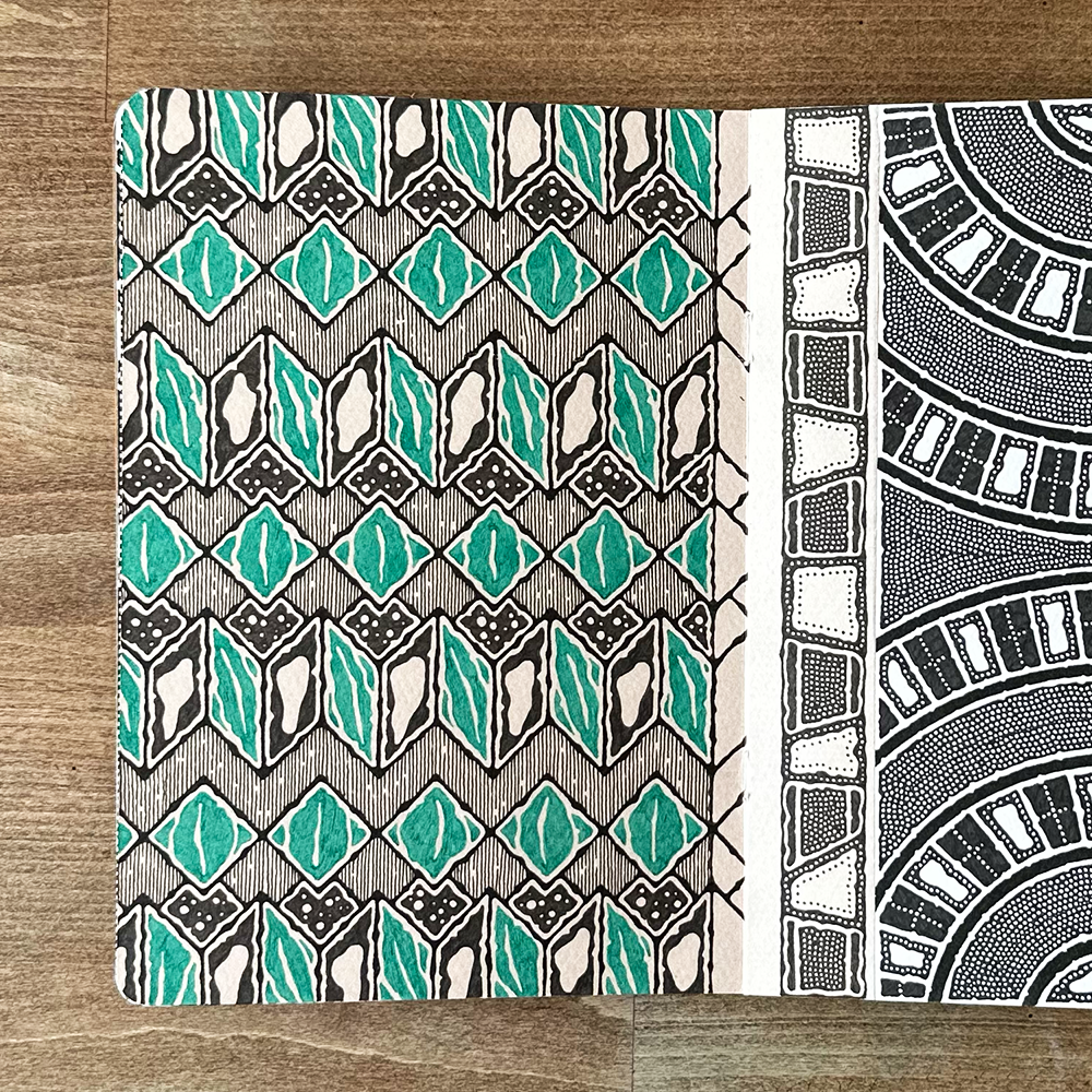 Two patterned pages on a wooden surface
