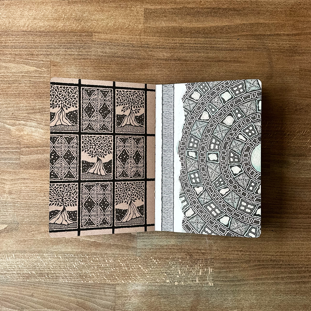 Two patterned pages on a wooden surface