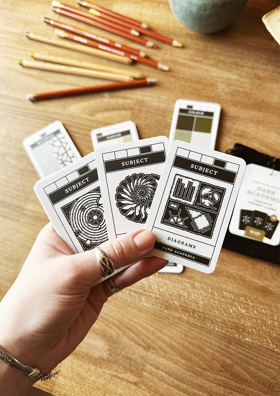 Hand holding cards on a wooden surface