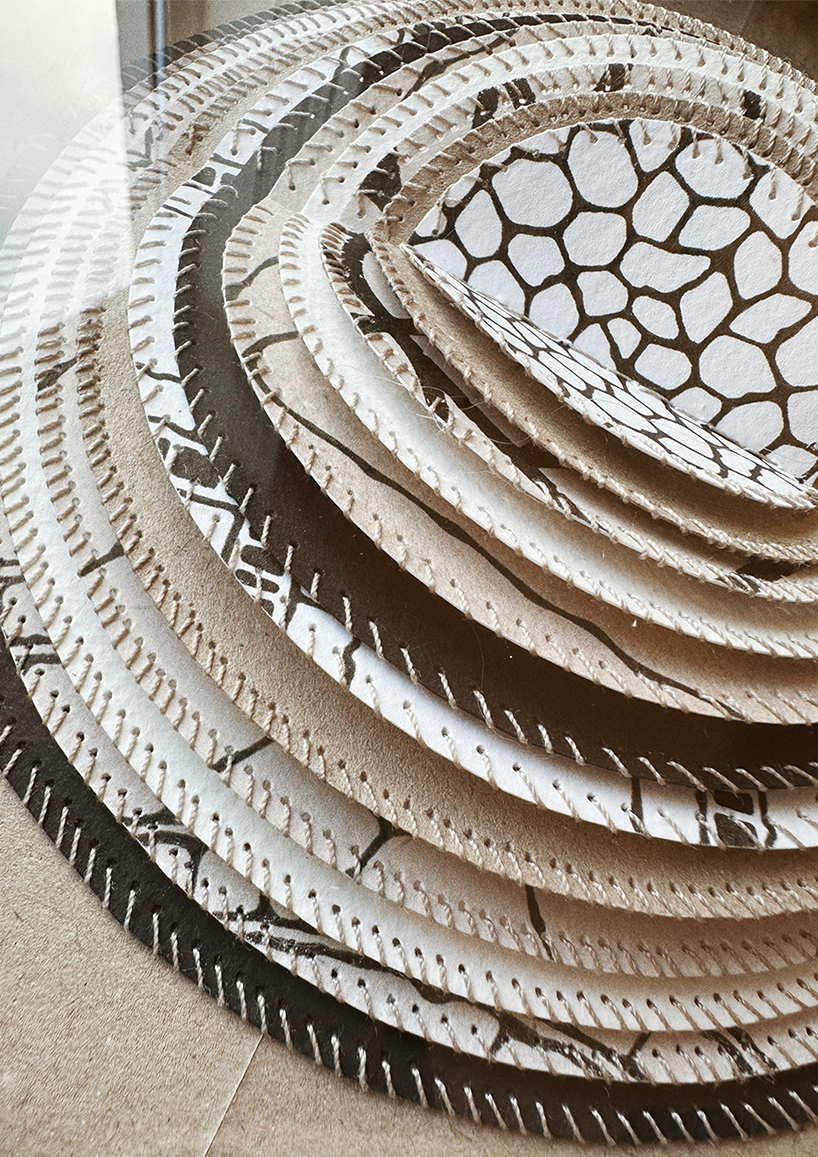 Stitched paper artwork in frame