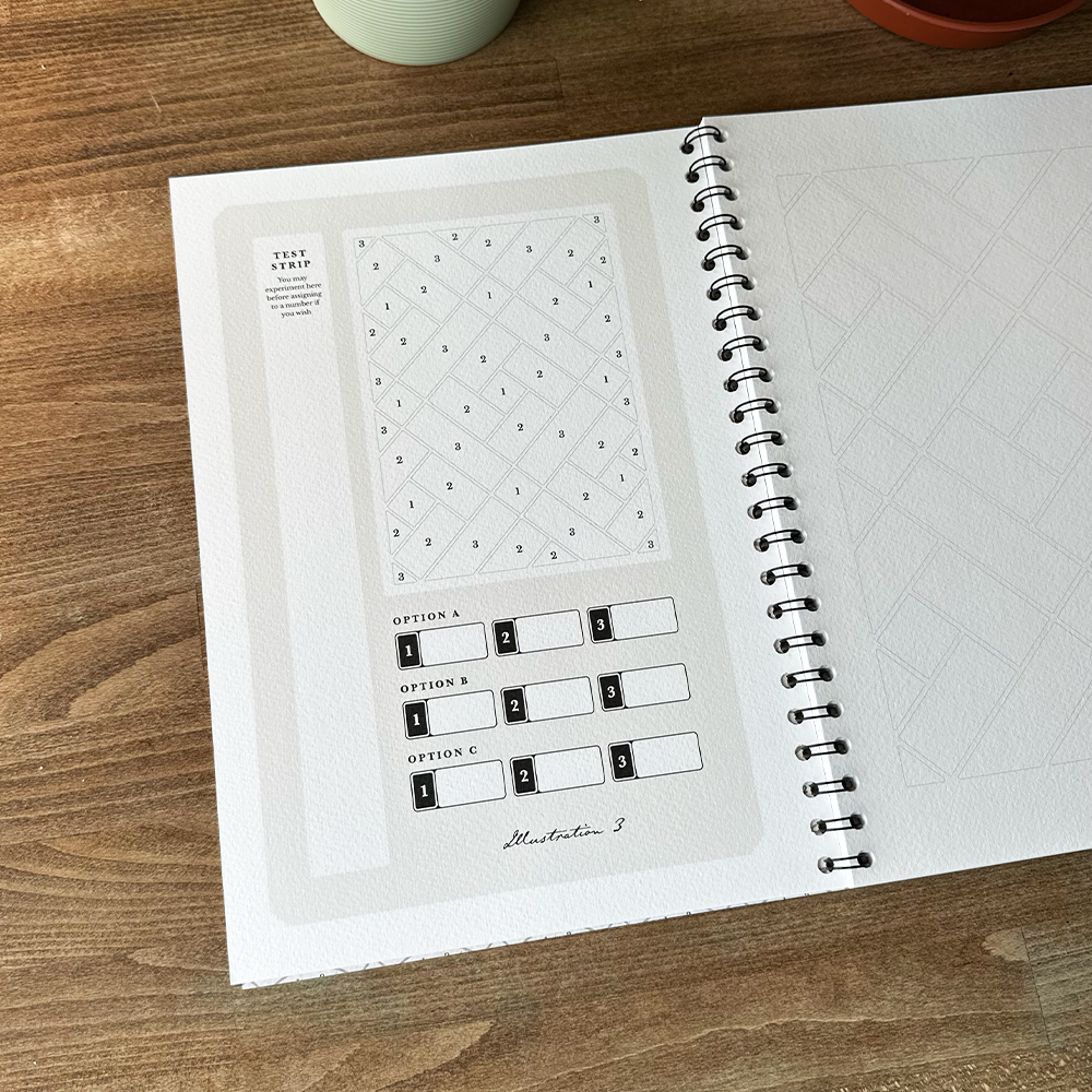 Open notebook with printed design on a wooden surface