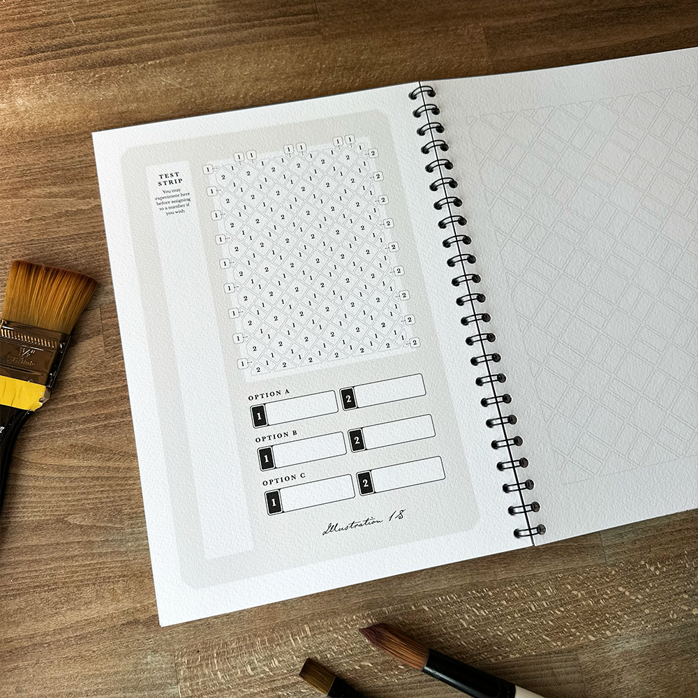 Open notebook with design templates on a wooden surface