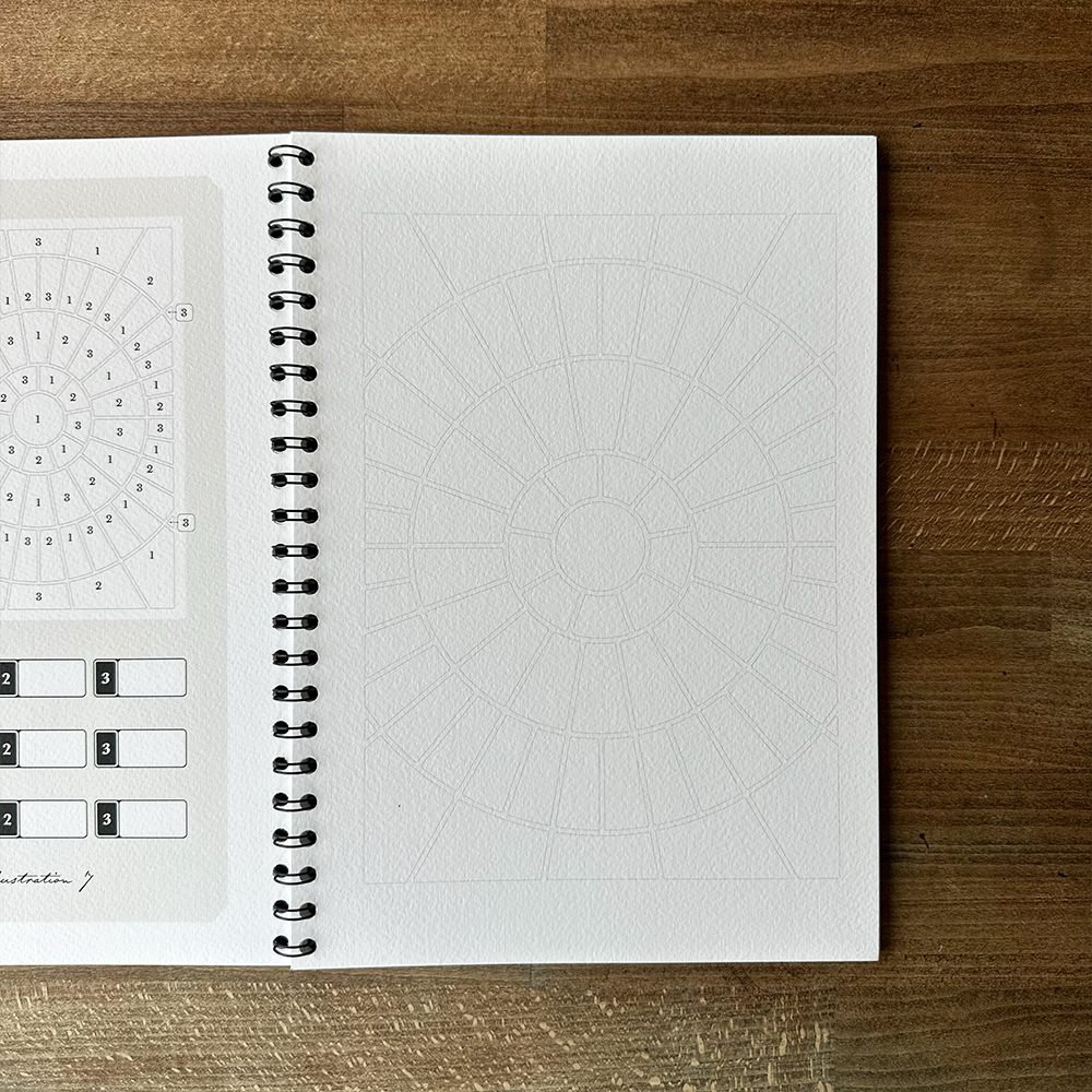 Open spiral-bound notebook with textured pages on a wooden surface