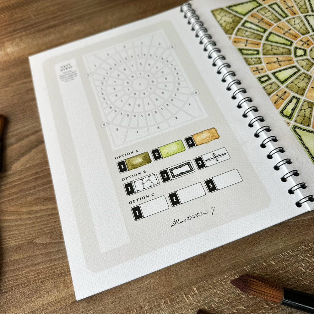 Open notebook with design illustrations on a wooden surface