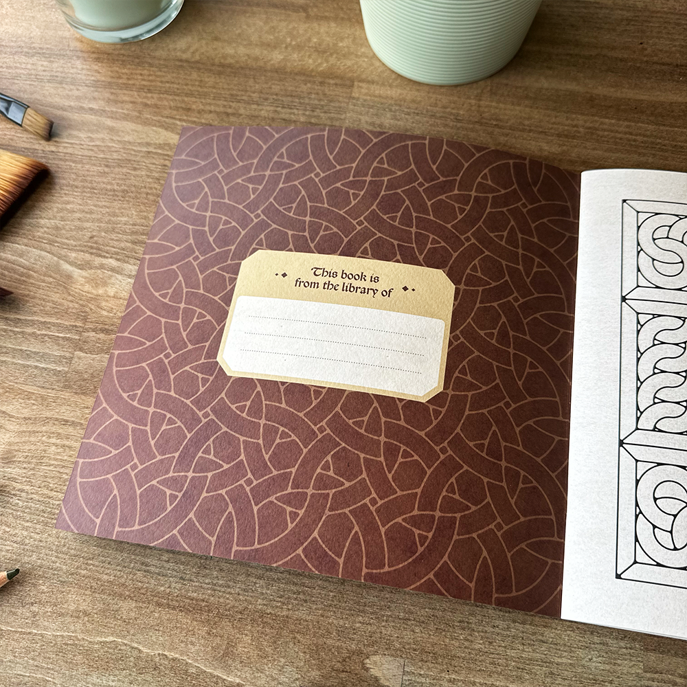 Brown book with decorative label on a wooden surface