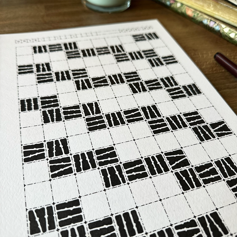 Pattern on a piece of paper with a pen and glass in the background.