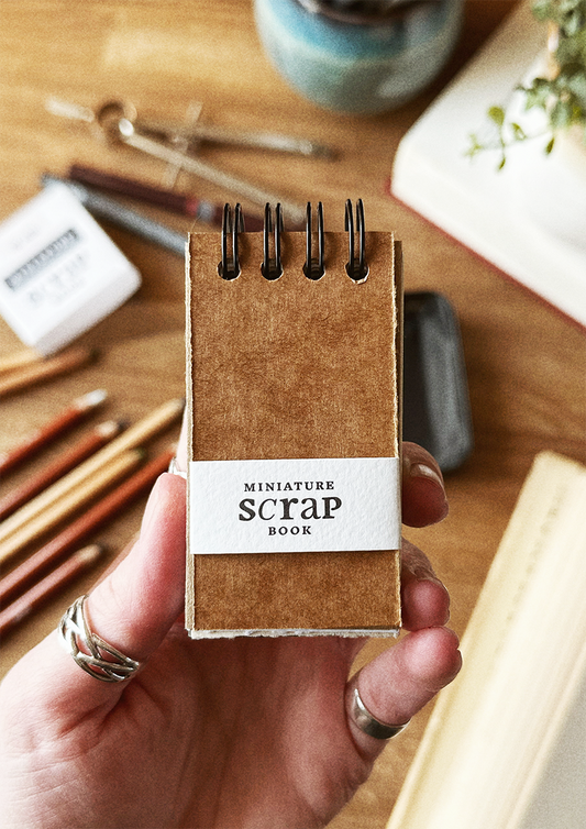 Miniature scrap book held in hand
