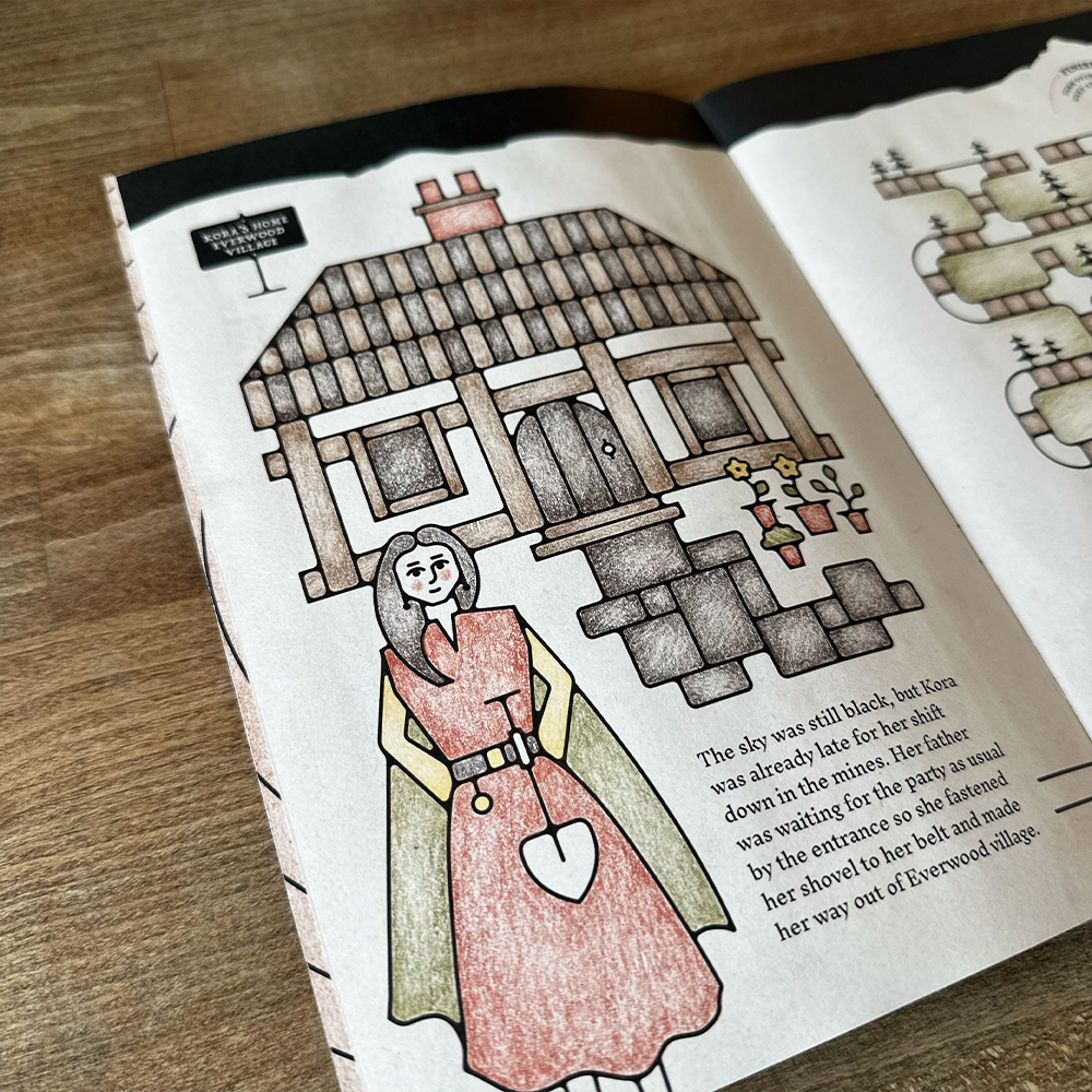 Illustrated book page with a woman and a wooden cabin on a wooden surface