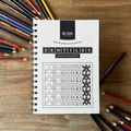 Zentiles guided drawing book by Blair Artworks on a wooden surface with colored pencils.