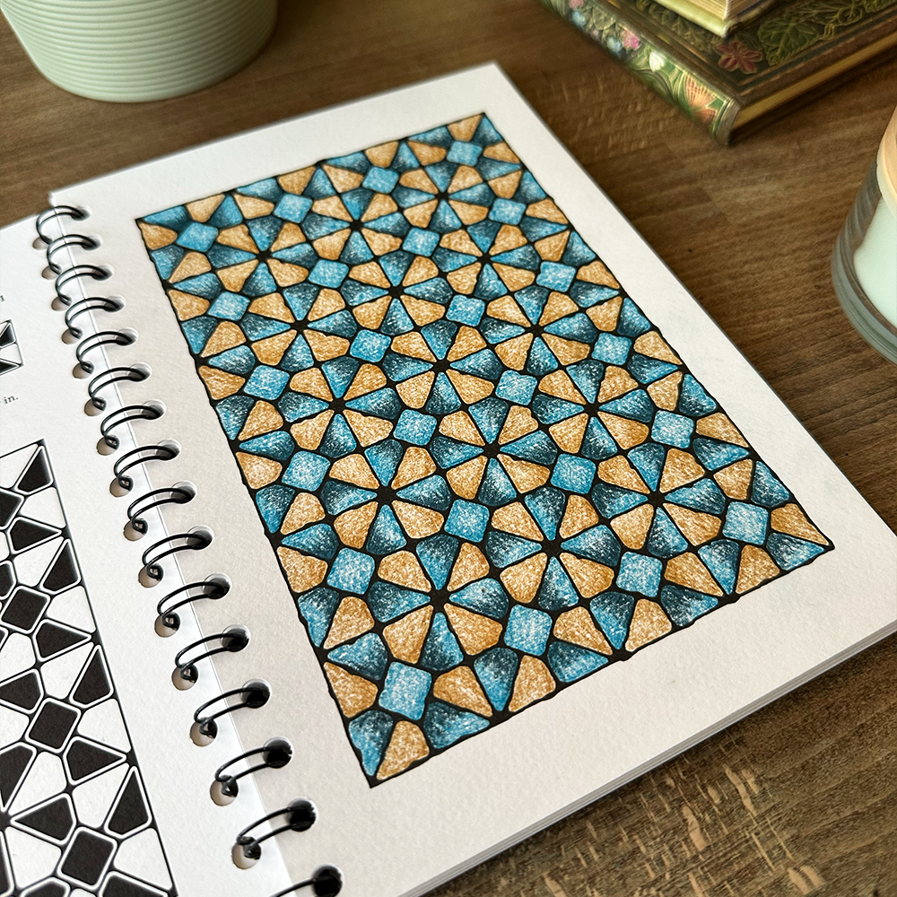 Coloring book with geometric pattern on a wooden surface
